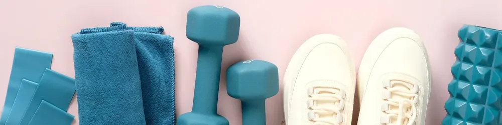 Fitness gear laid out on pink background